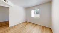 Located at 4040 E Fort Lowell Rd in Tucson, Arizona, this efficient one-bedroom, one-bathroom unit is thoughtfully laid out across a single floor. Light wood-style flooring runs throughout the entire space, creating a clean, cohesive look that ties each room together.

The living area features crisp white walls and a textured ceiling, offering a bright and neutral backdrop. It flows naturally toward the galley-style kitchen, which is equipped with warm wood cabinetry both above and below the counter, light-toned countertops, a stainless steel sink, and black appliances including a refrigerator and electric range — providing all essential cooking amenities in a compact, functional layout.

The bedroom is a well-proportioned, private retreat with white walls, a textured ceiling, and a window fitted with blinds that invites natural light while maintaining privacy. A dedicated closet adds practical storage to the room.

The bathroom continues the consistent wood-style flooring and includes a full tub-shower combination with a white surround, a toilet, and a wood-toned vanity with a sink — clean and functional in design.

Throughout the unit, the consistent use of light tones, wood flooring, and white walls creates a simple, tidy ambiance well-suited to efficient living in the heart of Tucson.