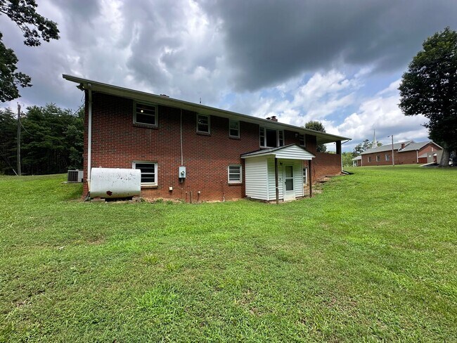 Building Photo - Spacious brick house with a caport and unf...