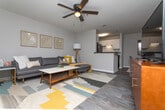 Located at 4801 Baker Grove Rd NW in Acworth, Georgia, this single-floor unit offers a well-designed layout that balances comfort and functionality. The living area is bright and inviting, featuring warm neutral tones, wood-look flooring, and a sliding door that allows natural light to fill the space. Framed wall art and a sectional sofa create a cozy, contemporary atmosphere.

The kitchen is efficiently designed with crisp white cabinetry, dark countertops, a tile backsplash, and black appliances, including a full-size refrigerator and electric range. Wood-look flooring continues throughout, adding visual continuity.

The unit includes two bedrooms, both finished with plush carpeting and ceiling fans. The primary bedroom is generously sized, featuring multiple windows that let in ample natural light, while the second bedroom offers a comfortable retreat with its own windows and ceiling fan.

The bathroom is well-appointed with wood-look tile flooring, a white vanity with dark countertops, a large mirror, and open shelving for added storage. Clean lines and neutral tones give the bathroom a polished, modern feel.

Throughout the unit, a cohesive neutral color palette, consistent finishes, and thoughtful design details come together to create a welcoming and functional living environment.