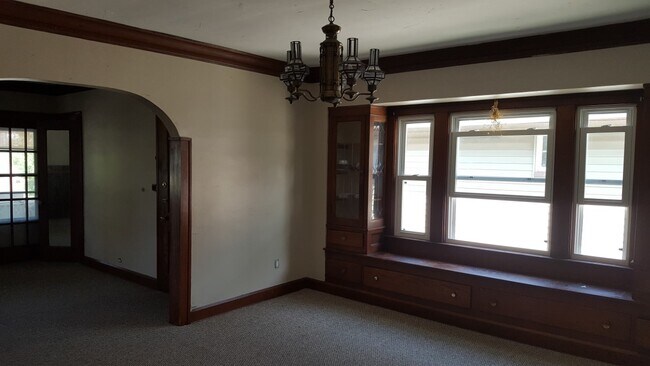 Large Dining Room with window seat and built in leaded glass storage cabinets. - 2021 Lincoln Ave