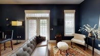 Located at 2522 McClintock Rd in Charlotte, NC, this single-floor residence showcases a thoughtfully designed interior with a cohesive blend of modern finishes and inviting character throughout.

The kitchen is a functional and visually striking space, featuring floor-to-ceiling white shaker cabinetry with glass-front upper panels, a textured mosaic tile backsplash, stainless steel appliances, and dark countertops. A built-in wine rack adds a refined touch, while wood-look flooring flows seamlessly into the adjacent dining area.

The living room makes a bold statement with deep navy accent walls, French doors that invite natural light, and hardwood-style flooring that adds warmth and continuity.

The bedroom features an elegant tray ceiling with a ceiling fan, a walk-in closet, and neutral toned walls that create a calm, restful atmosphere. A second bedroom or flex space mirrors this refined aesthetic with its own tray ceiling and open sightlines to the living area.

The bathroom is well-appointed with a long vanity, dark countertop, tile flooring, and a glass-enclosed walk-in shower, offering both practicality and clean, modern style throughout.