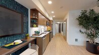Located at 1146 Harrison Street, Unit 527 in Seattle's vibrant South Lake Union neighborhood, this thoughtfully designed single-floor residence showcases a cohesive blend of contemporary style and functional living. The entry corridor sets an immediate design tone with bold geometric wallcovering and a glass-paneled barn door that provides a stylish transition between spaces.

The kitchen is outfitted with warm walnut-toned cabinetry, open display shelving, stainless steel appliances including a gas range and refrigerator, a subway tile backsplash, and a built-in dining counter—balancing efficiency with aesthetic appeal. Light hardwood flooring flows throughout, connecting the kitchen and living areas seamlessly.

The living room is a standout, featuring floor-to-ceiling windows that invite generous natural light and offer views of the surrounding urban streetscape. The bedroom is a calm retreat with a ceiling fan and neutral tones. The bathroom is boldly appointed with geometric patterned wallcovering, dark mosaic tile in the tub surround, large-format floor tile, and a wood-vanity with a clean white countertop. A dedicated hallway area accommodates stacked in-unit washer and dryer, adding everyday convenience. Throughout, curated artwork and vibrant accent colors elevate the overall character of the space.