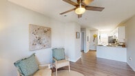 Located at 113 Brownlea Dr in Greenville, NC, this single-story home offers four bedrooms and one bathroom across a well-organized floor plan. The inviting living room greets you at the entrance with light-toned wood-look flooring, a ceiling fan with a brushed gold finish, and a front-facing window that draws in natural light. The space flows naturally toward the kitchen, which features white shaker-style cabinetry with brushed nickel hardware, granite countertops, a double sink, and a galley-style layout that leads to a rear exterior door. The four bedrooms are carpeted and finished with neutral-toned walls, textured ceilings, and flush-mount lighting. Several bedrooms include windows that bring in outside views, while others offer a quieter, more private setting. The shared bathroom is finished with tile flooring and includes a combined tub and shower. Throughout the home, clean white baseboards, a neutral color palette, and consistent finishes create a cohesive, move-in-ready atmosphere. The electrical panel is conveniently located in the kitchen area, and the home includes rear access to an outdoor patio space.