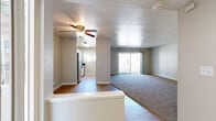 This well-appointed 3-bedroom, 3-bathroom single-story home at 3644 Kings Way in Sacramento, California offers a practical and comfortable layout throughout. The living room serves as the heart of the home, featuring a classic dark-surround fireplace, neutral carpet flooring, and a ceiling fan, with an open sightline that flows toward the entry area finished in hardwood-style flooring. The kitchen is thoughtfully updated with white cabinetry, dark stone countertops, stainless steel appliances including a dishwasher and electric range, tile-look flooring, and a window that brings in natural light with views of surrounding greenery. The primary bedroom is generously sized, boasting vaulted ceilings, dual mirrored sliding closet doors, a built-in vanity area, and multiple windows that fill the room with natural light. Additional bedrooms are carpeted and well-lit, with one featuring sliding glass doors that open to a private balcony with outdoor views. The three bathrooms are clean and functional, featuring light wood-look flooring, white vanities with dark hardware, large mirrors, and tub-shower combinations with chrome fixtures. A connecting hallway ties the layout together efficiently, making this home both comfortable and easy to navigate.
