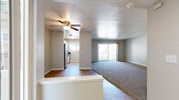 This well-appointed 3-bedroom, 3-bathroom single-story home at 3644 Kings Way in Sacramento, California offers a practical and comfortable layout throughout. The living room serves as the heart of the home, featuring a classic dark-surround fireplace, neutral carpet flooring, and a ceiling fan, with an open sightline that flows toward the entry area finished in hardwood-style flooring. The kitchen is thoughtfully updated with white cabinetry, dark stone countertops, stainless steel appliances including a dishwasher and electric range, tile-look flooring, and a window that brings in natural light with views of surrounding greenery. The primary bedroom is generously sized, boasting vaulted ceilings, dual mirrored sliding closet doors, a built-in vanity area, and multiple windows that fill the room with natural light. Additional bedrooms are carpeted and well-lit, with one featuring sliding glass doors that open to a private balcony with outdoor views. The three bathrooms are clean and functional, featuring light wood-look flooring, white vanities with dark hardware, large mirrors, and tub-shower combinations with chrome fixtures. A connecting hallway ties the layout together efficiently, making this home both comfortable and easy to navigate.