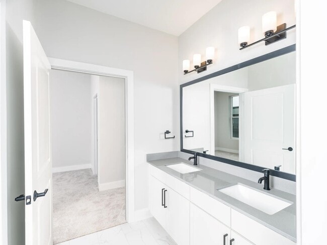 Designer bathrooms featuring quartz countertops and dual sinks for ultimate comfort and style. - Modera Liberty Row
