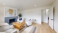 Located at 3732 N Stevens St in Tacoma, WA, this two-story home offers a thoughtfully designed layout spread across two floors. Light hardwood flooring flows throughout, complementing the clean, neutral palette that defines the interior aesthetic.

The main floor hosts the primary living and entertaining areas. The living room is anchored by a painted brick fireplace and large panoramic windows that frame views of the surrounding tree line, filling the space with natural light. Recessed lighting adds to the bright, open ambiance. The adjacent dining area features a modern sputnik-style chandelier and its own wide picture window overlooking greenery, creating an inviting atmosphere for meals. The kitchen is outfitted with warm wood cabinetry, white countertops, stainless steel appliances, and a window above the sink.

Upstairs, three bedrooms offer comfortable retreats, each with generous windows providing neighborhood views and natural light. The primary bedroom is a well-proportioned space with dual windows. Two bathrooms serve the home—one featuring dark tile surround, a soaking tub, and gold fixtures, while the second is clean and functional. A dedicated exercise room adds versatile utility, rounding out a practical and well-balanced floor plan.