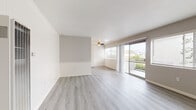 Located at 2059 W Artesia Blvd in Torrance, California, this single-floor unit offers a well-organized layout that balances comfort and functionality. The living area is a standout feature, showcasing light gray laminate flooring, neutral-toned walls with wainscoting accents, and a ceiling fan overhead. Large sliding glass doors open to a private balcony, flooding the space with natural light and offering views of the surrounding neighborhood and greenery. An additional window further enhances the bright, airy atmosphere. The kitchen is designed with ample white cabinetry featuring matte black hardware, light countertops, a built-in wall oven, microwave, and a single-basin sink — all set atop matching laminate flooring for a cohesive look. The bedrooms are carpeted for warmth and comfort, each equipped with ceiling fans and slatted windows for natural ventilation and light control. One bedroom features a sliding mirrored closet and direct access to a bathroom. Two bathrooms serve the unit, both finished with white cabinetry, dark speckled countertops, and light wood-look flooring. One includes a full tub-shower combination with clean white tile surround. The overall design is clean, bright, and move-in ready.