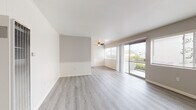 Located at 2059 W Artesia Blvd in Torrance, California, this single-floor unit offers a well-organized layout that balances comfort and functionality. The living area is a standout feature, showcasing light gray laminate flooring, neutral-toned walls with wainscoting accents, and a ceiling fan overhead. Large sliding glass doors open to a private balcony, flooding the space with natural light and offering views of the surrounding neighborhood and greenery. An additional window further enhances the bright, airy atmosphere. The kitchen is designed with ample white cabinetry featuring matte black hardware, light countertops, a built-in wall oven, microwave, and a single-basin sink — all set atop matching laminate flooring for a cohesive look. The bedrooms are carpeted for warmth and comfort, each equipped with ceiling fans and slatted windows for natural ventilation and light control. One bedroom features a sliding mirrored closet and direct access to a bathroom. Two bathrooms serve the unit, both finished with white cabinetry, dark speckled countertops, and light wood-look flooring. One includes a full tub-shower combination with clean white tile surround. The overall design is clean, bright, and move-in ready.