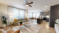 Located at 13475 Rincon Dr in Houston, TX, this thoughtfully designed 2-bedroom, 2-bathroom residence offers a comfortable and modern single-floor layout. The open-concept living, dining, and kitchen area forms the heart of the home, with light wood-look flooring, neutral tones, and ceiling fans creating a bright, cohesive atmosphere throughout.

The kitchen is a standout feature, showcasing dark wood cabinetry with under-cabinet lighting, granite countertops, a tile backsplash, stainless steel appliances, and a center island with bar seating. Adjacent to the kitchen, the dining area is bathed in natural light from a wall of large windows dressed with sheer curtains and blinds. The spacious living room continues the open feel, offering generous wall space and seamless flow between areas.

The generously sized primary bedroom features a ceiling fan, large windows, and wood-look flooring. Both bathrooms are finished with dark wood vanities, granite countertops, tile flooring, and tub-shower combinations, reflecting the same modern aesthetic found throughout the home. The second bedroom is equally well-lit, with large windows and a calm, neutral palette.

Two dedicated closets provide ample storage. The overall design balances contemporary finishes with a warm, livable ambiance.