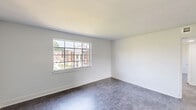 Located at 2343 Memorial Ave SW in Roanoke, Virginia, this two-bedroom, one-bathroom single-floor residence offers a thoughtfully organized layout across a comfortable footprint. The interior features consistent tile flooring throughout, clean white walls, and abundant natural light drawn in through multi-pane windows that frame views of the surrounding neighborhood.

The spacious primary bedroom accommodates generous furnishings and includes its own closet, while the second bedroom is well-sized with a window providing additional natural light. Each room benefits from a neutral palette that offers flexibility for personalization.

The kitchen is equipped with white cabinetry featuring brushed nickel hardware, light marble-style countertops, a black electric range with an overhead exhaust hood, and tile flooring — creating a clean, functional cooking space. Adjacent to the kitchen, the dining area flows naturally into the living room, supporting an open and connected everyday living experience.

The full bathroom is finished with classic white subway tile wainscoting, a black-and-white mosaic tile floor, a soaking tub, toilet, and a window that provides natural ventilation and light. A central hallway connects the bedrooms, bathroom, and living areas efficiently. Two closets provide practical storage throughout the unit.
