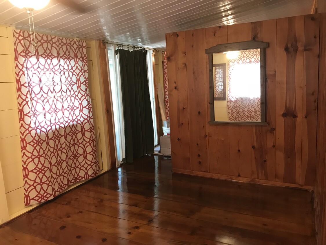 Sliding glass doors allow easy access to back porch in the fenced in backyard - 1407 W Church St