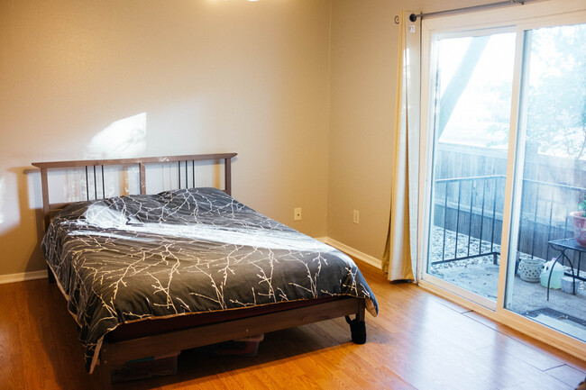 Well-lit bedroom with access to private balcony - 2021 Bluebonnet Ln.