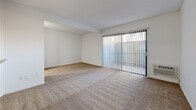 Located at 1942 Deerpark Dr in Fullerton, California, this efficiently designed single-floor unit offers a practical and clean layout across its compact footprint. The combined kitchen and living area forms the heart of the space, with the living room featuring neutral carpet flooring, bright white walls, and a textured ceiling. A wall-mounted air conditioning unit ensures year-round comfort, while a full-width sliding glass door fitted with vertical blinds allows natural light to pour in and provides access to the outdoors.

The kitchen is thoughtfully appointed with white cabinetry, granite-style countertops, a stainless steel sink, a white electric range, and a full-size refrigerator. Wood-style vinyl flooring runs throughout the kitchen, creating a clean contrast to the carpeted living area. A pass-through counter connects the kitchen to the living space, enhancing the open feel between the two areas.

The bathroom continues the cohesive design aesthetic, featuring white cabinetry with granite-style countertops, an integrated sink, a large mirror, and wood-style vinyl flooring. The space is clean, functional, and well-lit. Overall, this unit presents a straightforward, move-in-ready layout suited for efficient, comfortable living in the Fullerton area.