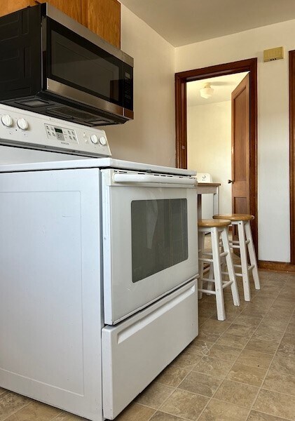 Kitchen includes dishwasher, fridge, microwave, stove, garbage disposal. - 101B N Mill St