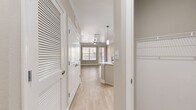 This sleek 640 square foot apartment in Oklahoma City offers a harmonious blend of comfort and contemporary design. The open-concept layout maximizes the use of space, creating a seamless flow between the living areas. The kitchen is a standout feature, boasting white cabinetry, stainless steel appliances, and a stylish hexagonal tile backsplash. A large island with a built-in sink serves as both a functional workspace and a casual dining area.

The living room is bathed in natural light thanks to large windows and a glass door leading to a private balcony. Light wood-look flooring runs throughout, adding warmth to the neutral color palette. The bedroom, measuring 150 square feet, offers ample space and includes a ceiling fan for comfort. 

The bathroom features a modern vanity, large mirror, and a combination tub-shower. Two closets provide generous storage options. Additional amenities include in-unit laundry facilities and central air conditioning. The apartment's design emphasizes clean lines and a minimalist aesthetic, creating a contemporary urban oasis perfect for modern living.