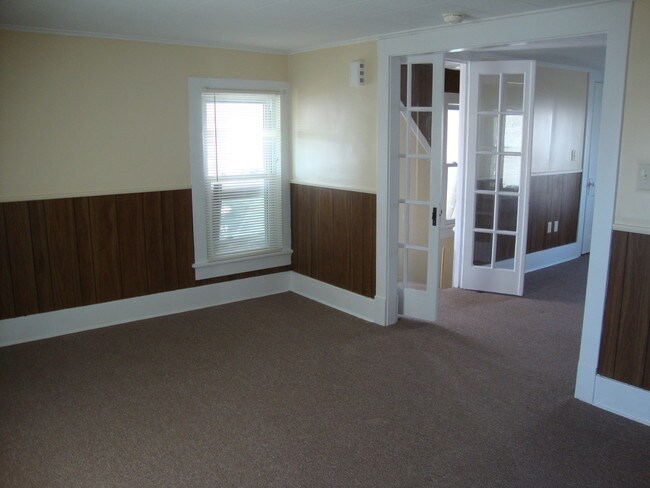 From kitchen door. Dining room and entryway. - 225 College Ave
