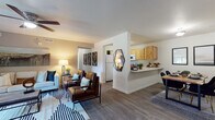 This single-floor residence at 3040 Central Avenue in Billings, Montana offers a well-designed, open-concept layout that seamlessly connects the living, dining, and kitchen areas. The living room is a comfortable and inviting space, featuring wood-style flooring, a ceiling fan, and a sliding glass door that fills the room with natural light and provides access to an outdoor patio area. The kitchen is equipped with warm, natural wood cabinetry, white appliances including a refrigerator, range, and microwave, light countertops, and a pass-through breakfast bar that connects to the dining area. The dining space accommodates a full table and flows naturally into the living room, creating a cohesive entertaining zone. The bedrooms are carpeted for comfort, each offering closet storage and large windows that allow in generous natural light. The two full bathrooms are finished with wood-tone vanity cabinetry, single-sink countertops, wood-style flooring, and a shower-tub combination. Throughout the residence, a consistent warm and modern aesthetic is maintained, with neutral wall tones complementing the natural wood finishes. The overall layout is functional and efficient, making excellent use of the available space across a single level.