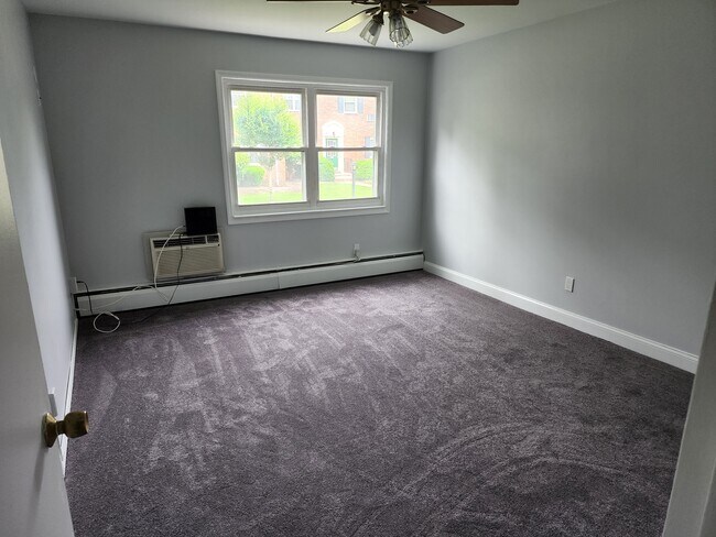 Bedroom of unit with A/C unit and walk-in closet. - 87 Roseland Ave