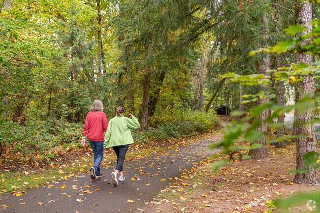 Residents enjoy daily walks through the wooded Cook Park Greenbelt, just a few steps from home.