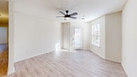 Located at 201 Tiliwa Ct in Clemson, SC, this single-floor, 3-bedroom, 2-bathroom home offers a practical and well-appointed layout throughout. Light wood-style flooring flows consistently across the living spaces, complemented by neutral wall tones and textured ceilings that create a clean, cohesive aesthetic.

The kitchen is a functional highlight, featuring granite countertops, white cabinetry, stainless steel appliances including a refrigerator, microwave, and range, as well as a double-basin sink. A peninsula-style breakfast bar separates the kitchen from the adjacent living area, which benefits from natural light through multiple windows and a glass-paneled exterior door. A ceiling fan adds comfort to the living room.

Each of the three bedrooms offers wood-style flooring and ceiling fans. The spacious primary bedroom includes a dedicated closet, while the additional bedrooms provide ample room for varied use. Three closets throughout the home offer generous storage options.

Both bathrooms are finished with granite vanity countertops, white cabinetry, and tub-shower combinations set on wood-style flooring. A dedicated laundry room with shelving and washer/dryer hookups adds everyday convenience to this well-designed Clemson home.