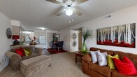 Located at 1615 Westlake Dr in Conway, Arkansas, this single-story 2-bedroom, 2-bathroom residence offers a well-organized and functional layout. The open-concept living and dining area serves as the heart of the home, featuring soft carpet flooring, a textured ceiling, and a ceiling fan with light fixture that keeps the space comfortable year-round. A large window allows natural light to fill the living room, creating a bright and welcoming atmosphere.

The kitchen flows directly from the living and dining area and is equipped with light wood cabinetry, a peninsula breakfast bar, hardwood-style flooring, a full suite of white appliances including a range, dishwasher, and refrigerator, and ample counter space for meal preparation. A hallway connects the main living areas to the private quarters of the home.

Both bedrooms are carpeted and feature ceiling fans, neutral walls, and windows that bring in natural light. The generously sized primary bedroom offers comfortable proportions ideal for a full bedroom suite. Each of the two full bathrooms features a tub and shower combination with sliding glass doors, light wood cabinetry, and hardwood-style flooring, providing practical and clean finishes throughout.