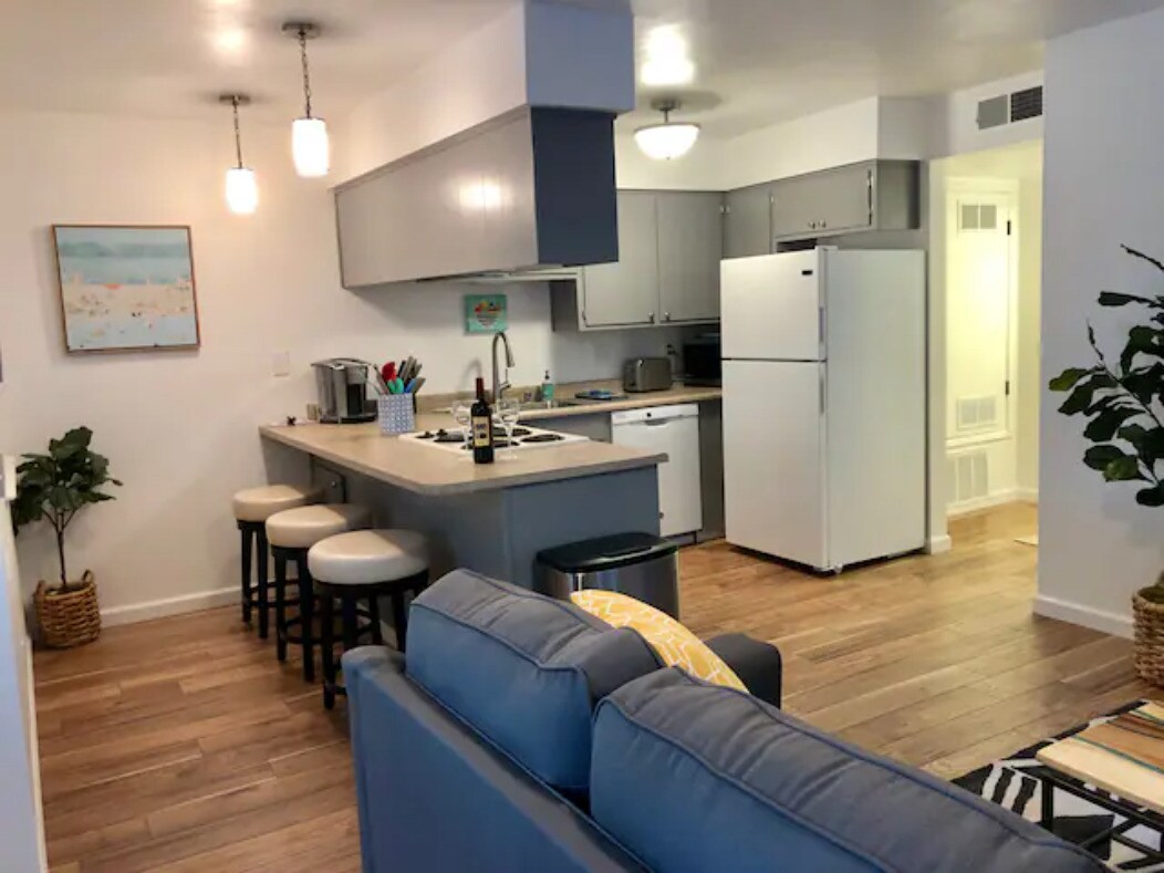 View from living room into kitchen and hallway to rooms. - Salem Suites - Furnished, Cable & Wi-Fi