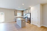 This two-story home in Jonesboro, GA offers a well-designed layout spread across two floors. The main level features an open-concept living and dining area with light hardwood flooring, crown molding, and French doors that invite natural light throughout. A ceiling fan and elegant chandelier add functional style to the common areas. The kitchen is a standout, showcasing gray shaker-style cabinetry, granite countertops, a tile backsplash, a central island, and a full suite of stainless steel appliances including a gas range, microwave, dishwasher, and refrigerator. A convenient half bathroom with a pedestal sink completes the main floor, along with access to the attached garage. Upstairs, four bedrooms provide comfortable retreats, with the generously sized primary bedroom featuring hardwood-style flooring and a ceiling fan. The additional bedrooms are carpeted and filled with natural light from bright windows. A dedicated closet offers wire-rack shelving for ample storage. Four full bathrooms serve the home throughout. Neutral tones and clean finishes create a bright, move-in-ready atmosphere suited for a variety of lifestyles.