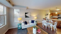 This single-floor, one-bedroom, one-bathroom residence offers a thoughtfully designed open layout that connects the living, dining, and kitchen areas seamlessly. The living room is a standout space, featuring rich hardwood-style flooring, a textured ceiling, and an expansive bank of large windows that flood the room with natural light and provide views of the surrounding landscape. The open flow continues into the dining area, making the space well-suited for both relaxing and entertaining.

The kitchen is well-equipped and functional, showcasing warm honey-toned cabinetry, granite countertops with a complementary tile backsplash, and stainless steel appliances including a dishwasher, range, and built-in microwave. A peninsula with additional counter space enhances both storage and workspace. Pendant lighting adds a finishing touch.

The bedroom is a serene retreat with plush carpeting, neutral walls, and a bright window overlooking the outdoors. It includes access to a generously sized walk-in closet outfitted with multi-tier wire shelving and hanging rods for ample storage.

The bathroom features a wide vanity with a white countertop, a large mirror with bright overhead lighting, and tile flooring, creating a clean and practical environment throughout.