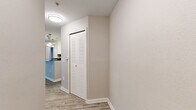 Located in Orlando, FL, this single-floor, 3-bedroom, 2-bathroom residence offers a thoughtfully designed layout with consistent modern finishes throughout. Wood-look plank flooring flows seamlessly across all rooms, complemented by neutral-toned walls and clean white trim that create a bright, cohesive aesthetic.

The kitchen is a standout feature, equipped with stainless steel appliances—including a range and refrigerator—white shaker-style cabinetry, dark granite countertops, and a peninsula with pendant lighting overhead. It opens conveniently toward the living area, enhancing the sense of connectivity in the space.

The living room is comfortably sized, featuring a ceiling fan and textured ceiling. The bedrooms are well-proportioned, each with ceiling fans, windows with blinds for natural light and privacy, and closet storage. The spacious primary bedroom offers ample room for furnishings.

Both bathrooms maintain a consistent design with white cabinetry, dark granite countertops, wood-look flooring, and full tub-shower combinations with white tile surrounds. A dedicated closet in the hallway provides additional storage. The overall ambiance is clean, modern, and move-in ready, making this Orlando residence a practical and attractive living space.