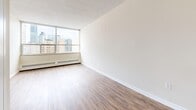 This 440 square foot apartment in downtown Toronto offers a compact yet functional living space. Located at 222 Elm St, the unit features two bedrooms, including a spacious primary bedroom of 170 square feet, and one bathroom. The single-floor layout includes two hallways for easy navigation between rooms.

Throughout the apartment, wood-look flooring adds warmth and durability to the space. The neutral-toned walls create a blank canvas for personalization. Large windows in the living area and bedrooms provide ample natural light and offer stunning views of the Toronto skyline, enhancing the sense of space.

The bathroom is equipped with modern fixtures, including a full-sized bathtub with shower functionality and a sleek toilet. White tiled walls contribute to a clean, bright aesthetic.

The apartment's compact size is efficiently utilized, with each room serving a specific purpose. Built-in storage solutions, such as closets, help maximize the available space. The unit also features baseboard heating, ensuring comfort during Toronto's colder months.

While cozy in size, this apartment's location in the heart of Toronto (M5T 1K5) offers easy access to the city's amenities. Its layout and features make it an ideal option for those seeking a functional living space in a prime urban location.