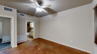 Located at 1509 Centre Place Dr in Denton, TX, this single-floor, one-bedroom, one-bathroom unit offers a practical and well-organized layout across a compact footprint. The living and kitchen areas feature distinctive polished concrete floors in warm earth tones, lending an industrial character to the space. The kitchen is efficiently designed with light maple cabinetry offering ample storage, dark countertops, and a full suite of black appliances including a refrigerator, electric range, built-in microwave, and dishwasher. A peninsula counter provides a natural divide between the kitchen and living area. The bedroom is a comfortable, well-proportioned room finished with patterned carpet and a ceiling fan with integrated lighting. A window fitted with horizontal blinds allows natural light to filter in. The bathroom is accessible from the bedroom area and features light maple vanity cabinetry with a granite-style countertop, a tub-shower combination with rich brown ceramic tile surround, and polished concrete flooring consistent with the rest of the unit. A dedicated closet provides additional storage. Neutral wall tones throughout create a clean, cohesive aesthetic, while ceiling fans in the main living and bedroom areas promote comfortable airflow year-round.
