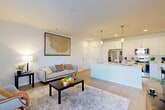 Located at 1551 Riverside Pkwy in Douglasville, GA, this well-designed one-bedroom, one-bathroom unit offers a thoughtful layout that maximizes its comfortable footprint. The open-concept living and kitchen area serves as the heart of the home, featuring light wood-style flooring, crisp white walls, and abundant natural light from large windows with views to the outdoors. The kitchen is outfitted with white shaker cabinetry, quartz countertops, a central island with a built-in sink and dishwasher, pendant lighting, and a full suite of stainless steel appliances including a refrigerator with ice maker, electric range, and over-the-range microwave. The living area flows naturally from the kitchen, offering a bright and open atmosphere with direct access to a private exterior door. The bedroom is carpeted for comfort, features a ceiling fan, and is illuminated by a large window that fills the room with natural light. The full bathroom maintains the unit's clean aesthetic with white subway tile in the tub/shower, a white vanity with quartz countertop, and wood-look tile flooring. A dedicated laundry area houses a full-size, top-load washer and dryer. A private closet and hall storage round out this efficiently designed, move-in-ready unit.
