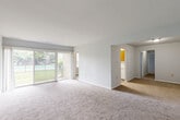 Located at 470 College Pkwy in Rockville, MD, this ground-floor unit offers a well-organized single-level layout across a comfortable footprint. The combined living and dining area serves as the heart of the home, featuring neutral carpeting, light-toned walls, and large sliding glass doors that flood the space with natural light and open directly onto a private patio overlooking a community pool. The open sightlines between the living and dining zones create a spacious, airy feel.

The kitchen is equipped with warm-toned wood cabinetry, white appliances including a gas range and refrigerator, light wood-style flooring, and a pantry for additional storage. A stacked washer and dryer is conveniently integrated within the kitchen area. The bathroom features a full tub-shower combination with classic white tile surround.

Both bedrooms are carpeted and receive natural light through windows with blinds. The primary bedroom is generously proportioned and includes a closet with bifold doors. The second bedroom is well-sized with its own window. Additional storage is provided by two closets throughout the unit, contributing to practical everyday functionality.