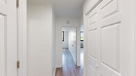 Located at 373 E Main St in Somerville, NJ, this one-bedroom, one-bathroom unit offers a thoughtfully arranged layout across a single floor. Light wood-style flooring flows consistently throughout the living spaces, lending a clean and cohesive aesthetic. The spacious living room is bathed in natural light through a large window with horizontal blinds, offering views of the surrounding Somerville skyline. A gold-toned ceiling fan adds a contemporary accent overhead. The generously sized primary bedroom features double closet doors for ample storage, connecting seamlessly to the rest of the unit via the hallway. The kitchen is well-appointed with gray shaker-style cabinetry, granite-look countertops, a tile backsplash, stainless steel refrigerator, and a dishwasher — all set on light tile flooring. The full bathroom maintains a crisp, all-white palette with a tub and shower combination enclosed by sliding glass doors, a wide vanity with mirror, and white tile walls. Throughout the unit, the neutral white walls and consistent finishes create a bright, move-in ready atmosphere suited for everyday living in the heart of downtown Somerville.