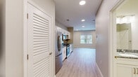 Located at 1112 S Grant Ave in Springfield, MO, this thoughtfully designed single-floor unit makes efficient use of its compact footprint across a well-organized layout. The open-concept kitchen and living area serves as the heart of the space, bathed in natural light from a large window offering pleasant outdoor views of mature trees and green surroundings. Light wood-tone luxury vinyl plank flooring flows throughout the living areas, complementing the neutral warm-gray wall palette and creating a clean, contemporary aesthetic.

The kitchen is a standout feature, outfitted with crisp white shaker-style cabinetry, granite countertops, a textured tile backsplash, and a full suite of stainless steel appliances including a refrigerator, range, over-the-range microwave, and dishwasher. Recessed lighting illuminates both the kitchen and living area, while a ceiling fan adds comfort to the living space.

The bathroom is finished with light tile flooring, a vanity topped with granite counters, and brushed nickel fixtures, maintaining the modern aesthetic found throughout. Additional functionality is provided by a dedicated laundry room, a utility room, and a closet for storage. The space is clean, move-in ready, and well-suited for efficient, comfortable everyday living.