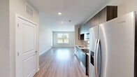 Located on Pelham Road in Greenville, SC, this well-appointed one-bedroom, one-bathroom unit offers a thoughtfully designed layout across a single floor. The open-concept living and kitchen area creates a seamless flow, anchored by light-toned luxury vinyl plank flooring that runs throughout the main living spaces. The modern kitchen is outfitted with dark wood-grain cabinetry, a subway tile backsplash, white quartz countertops, a stainless steel undermount sink, and a full suite of stainless steel appliances including a refrigerator with ice maker, electric range, microwave, and dishwasher. Recessed lighting illuminates the kitchen and living area, which features large windows that invite abundant natural light and outdoor views. The bedroom is comfortably sized, finished with plush carpet, a ceiling fan, and a window overlooking the surrounding landscape. Three closets provide generous storage throughout the unit, including a walk-in closet with wire shelving and carpet flooring. The bathroom features a full soaking tub with a clean, all-white surround. Neutral wall tones and a consistent, contemporary aesthetic unify the space, making it a practical and modern residence in Greenville.