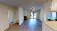 Located at 5425 Snyder Ln in Rohnert Park, California, this single-floor unit offers a well-designed layout that balances comfort and functionality. The living area is a standout space, featuring hardwood-style flooring, a ceiling fan, a tile-surround fireplace, and a sliding glass door that opens to a private outdoor area, filling the room with natural light and providing views of the surrounding neighborhood. The kitchen is thoughtfully laid out with white cabinetry offering generous storage, light countertops, a double sink, and white appliances including a range and refrigerator. Light wood-style flooring carries through the kitchen, keeping the space bright and clean. The bedroom features plush carpeting and a large window that invites natural light and outdoor views, creating a calm and restful atmosphere. The bathroom is clean and practical, complete with a white vanity with under-cabinet storage, a well-lit mirror, and a full bathtub and shower combination. Throughout the unit, neutral tones and light-colored walls create a cohesive, airy ambiance. The overall layout is efficient and open, making excellent use of the available space across the single floor.