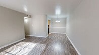 Located at 3400 Joyce Lane in Denton, TX, this 2-bedroom, 1-bathroom unit offers a practical and cohesive single-floor layout finished with consistent wood-look flooring throughout every room. The living room serves as the heart of the unit, featuring neutral gray walls, bright white trim and baseboards, and a large front-facing window that invites abundant natural light while a front entry door anchors the space. The open sightlines from the living area connect naturally to the hallway and the rest of the unit, creating an easy flow between rooms. The kitchen is efficiently arranged and includes a full-size refrigerator alongside ample cabinetry, keeping everything accessible and organized. Both bedrooms continue the neutral color palette with gray walls and wood-look flooring; the primary bedroom is a comfortable size and benefits from natural light through a window fitted with white blinds, while the second bedroom also features a window and two closet doors, providing notable storage flexibility. The bathroom is clean and functional, equipped with a full tub-shower combination. Throughout the unit, white panel doors, consistent trim work, and a unified color scheme of warm grays create a cohesive and move-in-ready atmosphere well-suited to comfortable everyday living.