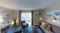 This single-floor residence on Shrewsbury Lane in Indianapolis offers a thoughtfully designed layout with modern finishes throughout. The living room serves as the heart of the home, featuring wood-style flooring, a textured ceiling, and a large sliding glass door fitted with vertical blinds and drape panels that flood the space with natural light while providing direct access to an outdoor patio with exterior views.

Adjacent to the living area, the dining space features a pendant light fixture overhead and neutral walls that create an inviting setting for meals. The galley-style kitchen is well-equipped with white shaker cabinetry, marble-style countertops, black appliances including a range and refrigerator, a stainless steel sink, and wood-style flooring, offering ample storage and counter space along both sides.

The bedrooms are carpeted and generously sized, each with natural light from windows and closet space. The primary bedroom includes a spacious reach-in closet. The bathrooms feature white vanity cabinetry with marble-style countertops and a tub-shower combination, maintaining the clean, contemporary aesthetic found throughout the rest of the home.
