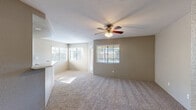 Located at 805 Regulo Place in Chula Vista, California, this two-bedroom, two-bathroom residence offers a well-organized single-floor layout. The open living area is bright and welcoming, featuring plush carpeting, a ceiling fan with light fixture, and multiple windows fitted with horizontal blinds that allow generous natural light to filter in. The kitchen is efficiently designed in a galley-style configuration, showcasing white cabinetry with ample storage, light quartz-style countertops, wood-look flooring, recessed lighting, and white appliances including a refrigerator, range, dishwasher, and microwave. A breakfast bar connects the kitchen to the living area, enhancing the open feel of the space. Both bedrooms are carpeted and equipped with ceiling fans, offering comfortable, well-lit retreats with windows overlooking the surroundings. The primary bedroom includes access to a closet. Both bathrooms feature tub-shower combinations with clean white tile surrounds, updated countertops, and wood-look flooring. A hallway and a dedicated closet contribute to practical storage throughout. The residence also includes a balcony with decorative iron railings, offering a serene view of the adjacent hillside landscaped with tall pines and native shrubs, providing a natural backdrop to this Chula Vista home.