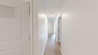 Located at 9400 Rainier Ave S in Seattle, WA, this 4-bedroom, 2-bathroom unit offers a well-organized single-floor layout designed for comfortable everyday living. The interior features a consistent, modern aesthetic throughout, with crisp white walls and clean finishes that create a bright and airy atmosphere.

A central hallway with light wood-tone flooring connects the main living areas and serves as the spine of the floor plan. The living room provides an open, versatile space with neutral carpeting that extends into all four bedrooms, offering a warm and comfortable feel underfoot. Each bedroom is thoughtfully sized, with the primary bedroom offering the most generous footprint. Several bedrooms include closets — including a walk-in closet in the primary — providing ample storage. The rooms are bathed in natural light and feature clean white walls, making them easy to personalize.

The two bathrooms are identically appointed with light wood-tone flooring, modern vanities featuring dark wood cabinetry, white countertops, large mirrors with overhead lighting, and full tub-shower combinations. The overall design is clean and contemporary. The efficient layout of this unit maximizes usable space, making it a practical and attractive option in Seattle's Rainier Beach neighborhood.