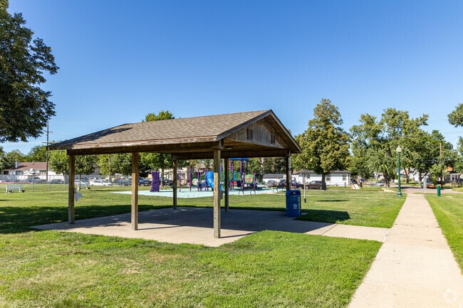 Whittier Park visitors enjoy shaded picnic tables and a large playground.