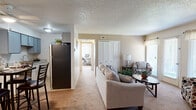 Located at 3860 Patrick Dr in Colorado Springs, CO, this single-floor residence offers a well-organized and functional layout across a comfortable footprint. The living room serves as the heart of the home, featuring warm carpeted flooring, a textured ceiling, and a generous closet with louvered doors. Natural light filters in through window treatments, while a glass patio door provides direct outdoor access and an airy feel to the space. Adjacent to the living area, the dining nook is defined by a tray-style ceiling detail and is accented by a decorative mirror, creating an intimate setting for meals. The kitchen area connects seamlessly, with a full-size refrigerator and dedicated dining space. The primary bedroom is a restful retreat with plush carpet, a large window dressed in sheer curtains and blinds, and ample wall space. A second room with its own closet and window offers flexibility as a home office or guest space. The bathroom features tile flooring, a granite-topped vanity with white cabinetry, and a tub-shower combination. Throughout the residence, a neutral color palette and consistent finishes contribute to a cohesive, move-in-ready atmosphere suited for comfortable everyday living in Colorado Springs.