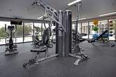This single-floor fitness center provides a dedicated environment for exercise and physical wellness. The layout is contained within one level, offering convenient access to all areas without the need to navigate between floors. As a fitness facility, the space is purpose-built to accommodate a range of workout activities, with the open floor plan allowing for flexible arrangement of equipment and exercise zones. The design prioritizes functionality, ensuring that the space supports the needs of its users efficiently. Without additional structural or design details, the center stands as a practical and accessible venue for health and fitness pursuits, serving as a centralized hub for physical activity within its broader setting.