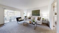 Located at 655 Baker St in Costa Mesa, California, this single-story 2-bedroom, 1-bathroom home offers a well-designed layout with a clean, neutral aesthetic throughout. The living room is generously sized, featuring plush carpeting, large sliding glass doors that invite abundant natural light, and views of the outdoors — creating an open, airy atmosphere ideal for relaxing or entertaining. The kitchen is appointed with white cabinetry, dark granite-style countertops, a peninsula breakfast bar, stainless steel appliances, and light wood-style flooring, offering both style and functionality. The spacious primary bedroom features soft carpeting, recessed lighting, and a hallway leading directly to the shared bathroom, providing added convenience. The second bedroom is equally comfortable, highlighted by a large window with outdoor views and plush carpet flooring. The full bathroom is finished with white cabinetry, dark countertops, a wide vanity mirror, and wood-style flooring. Two dedicated closets — including a walk-in — offer ample storage. The home's consistent use of neutral tones, soft textures, and natural light creates a cohesive and inviting living environment throughout.