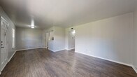 Located at 3409 North St in Nacogdoches, TX, this 2-bedroom, 1-bathroom single-story home offers a practical and well-organized layout. The combined living and dining area forms the heart of the home, showcasing rich dark hardwood-style flooring, neutral gray walls, and a large front window that fills the space with natural light and views of the surrounding grounds. A six-panel entry door adds a classic touch to the welcoming main area.

The kitchen is positioned behind a half-wall partition with a pass-through opening, creating a semi-open feel while maintaining a defined cooking space. It features white cabinetry, light speckled countertops, a double stainless steel sink, a black electric range, and a dishwasher, along with a pantry for additional storage.

Both bedrooms are carpeted and include ceiling fans. Each bedroom features a closet with bifold doors, and one bedroom benefits from a window that lets in natural light. The shared full bathroom offers a tiled shower-tub combo with chrome fixtures and hardwood-style flooring.

A hallway connects the private areas of the home, and four closets throughout provide ample storage. The layout is efficient and thoughtfully arranged, making this home a comfortable and functional residence.