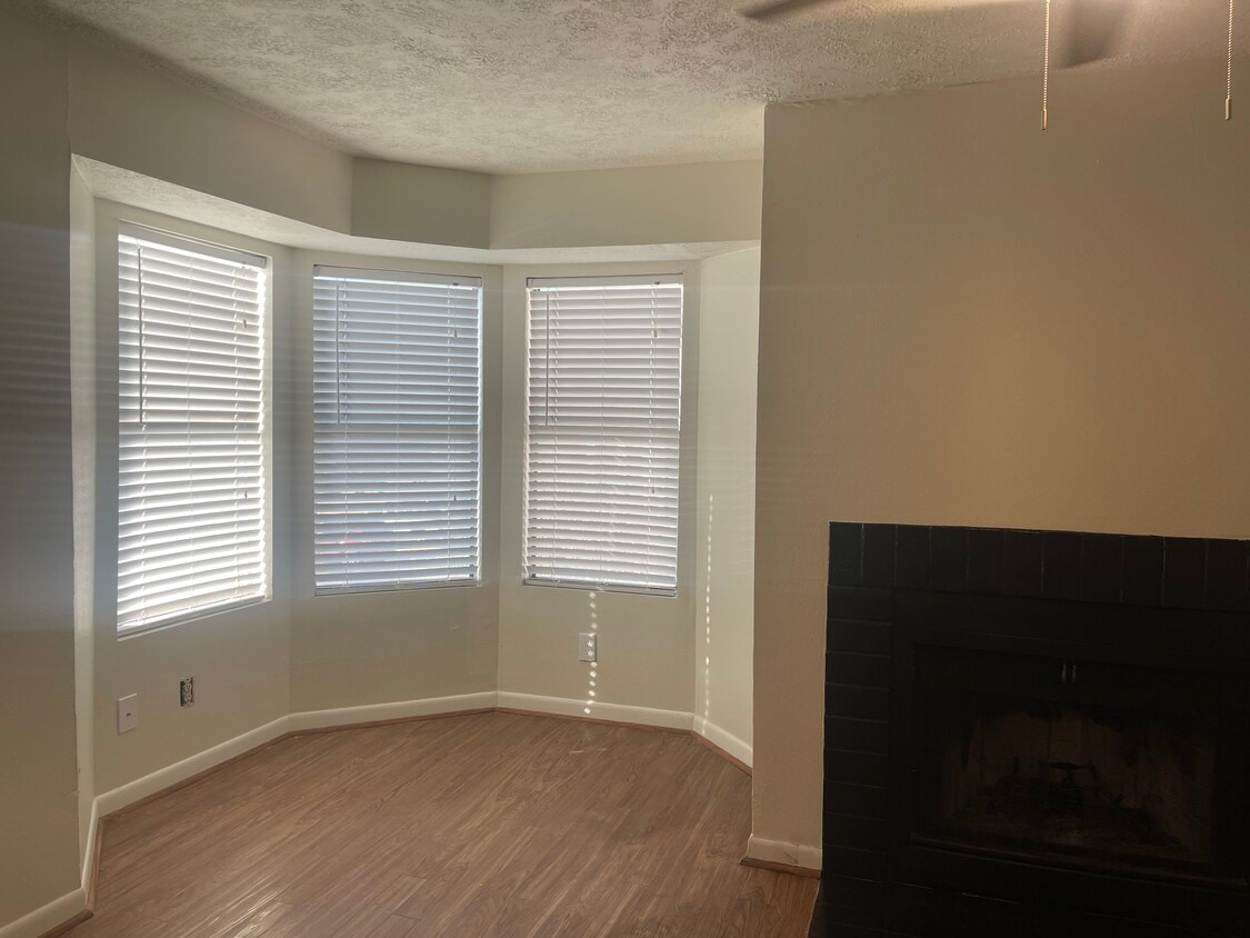 Bay window in living room with fireplace - 4441 Old College Rd