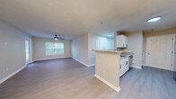 Located at 2423 Martin Luther King Dr in Atlanta, GA, this well-appointed 2-bedroom, 2-bathroom residence offers a functional and comfortable single-floor layout. Light wood-style flooring flows throughout the main living areas, complementing the neutral color palette and creating a bright, cohesive aesthetic.

The kitchen is a standout feature, showcasing white shaker cabinetry with black hardware, granite countertops, stainless steel appliances including a dishwasher and range, and a peninsula that opens to the dining and living areas. The dining space is accentuated by a striking sputnik chandelier, adding a modern touch to the overall design.

Both bedrooms are generously sized, featuring plush carpeting, ceiling fans, and windows that invite natural light. The spacious primary bedroom includes its own closet. Two full bathrooms serve the residence, each finished with white vanity cabinetry, granite countertops, and tub/shower combinations with clean tile surrounds.

Additional highlights include a dedicated laundry room, two closets for ample storage, and a hallway connecting all areas seamlessly. The consistent use of light tones, modern fixtures, and quality finishes throughout gives this residence a clean, move-in-ready feel.