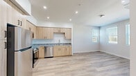 Located at 580 Media Pl in Sacramento, CA, this two-bedroom, two-bathroom residence offers a thoughtfully designed single-floor layout with a clean, contemporary aesthetic throughout. The open-concept kitchen is a standout feature, showcasing light wood cabinetry, granite countertops, a mosaic tile backsplash, and a full suite of stainless steel appliances including a refrigerator, range, microwave, and dishwasher. Recessed lighting and light wood-look flooring add to the bright, modern feel of the kitchen and living areas. Both bedrooms are carpeted for comfort and warmth, each featuring neutral tones, natural light through horizontal-blind windows, sliding panel closets, and wall-mounted mini-split HVAC units for individual climate control. The two bathrooms mirror the home's consistent design language, with light wood vanities, granite countertops, tub-shower combinations with tiled surrounds, and light wood-look flooring. A connecting hallway ties the layout together efficiently. The overall ambiance is clean, modern, and move-in ready, with cohesive finishes throughout that create a comfortable and functional living space.
